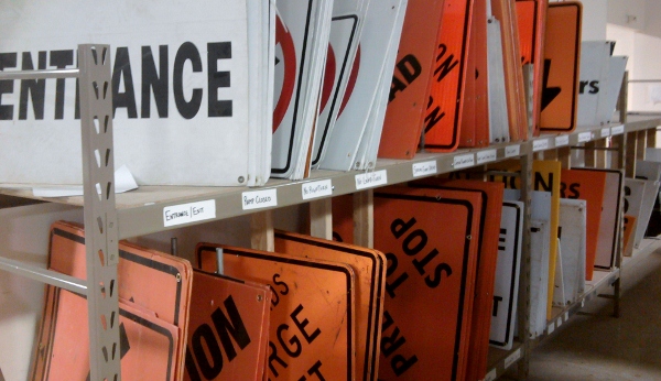 Road signs stored on shelving.