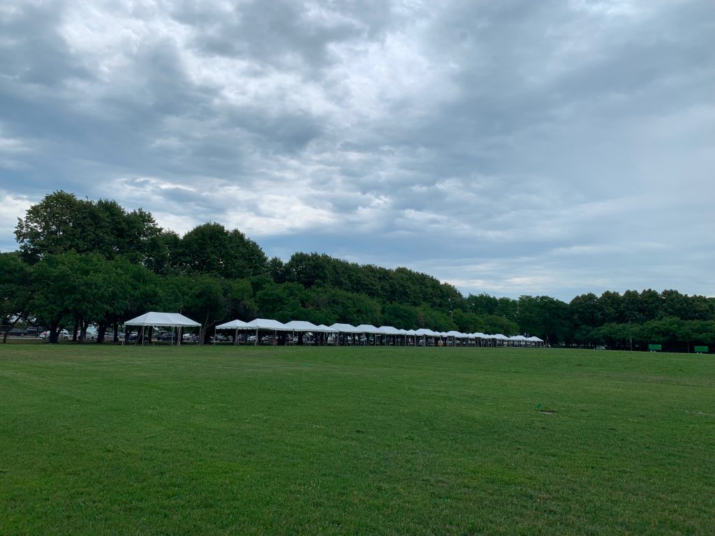 Frame tents measuring 10' x 20' set up outside.