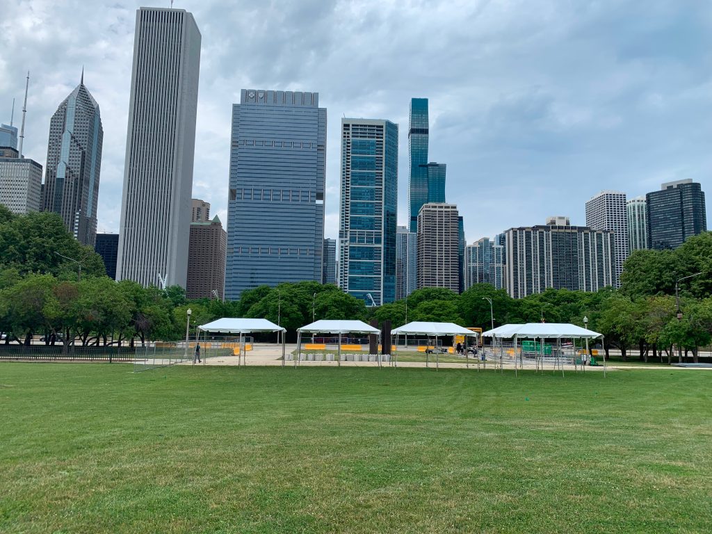 Frame tents measuring 10' x 20' set up outside with cityscape in the background.