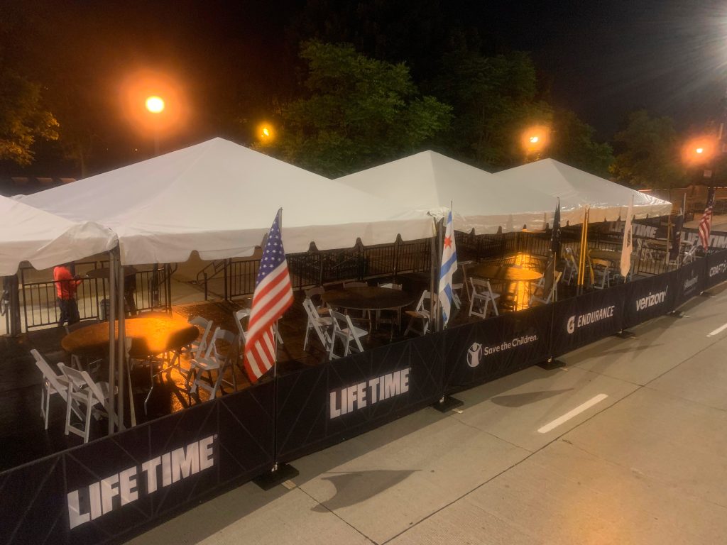 Frame tents measuring 15' x 15' set up outside at night.