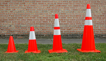 Four orange traffic cones of varying sizes.
