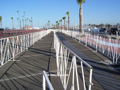 Boardwalk with palm trees in the background.