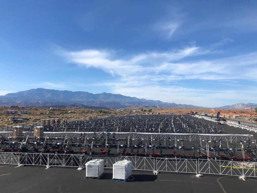 Hundreds of bike racks set up outside with mountains in the background.