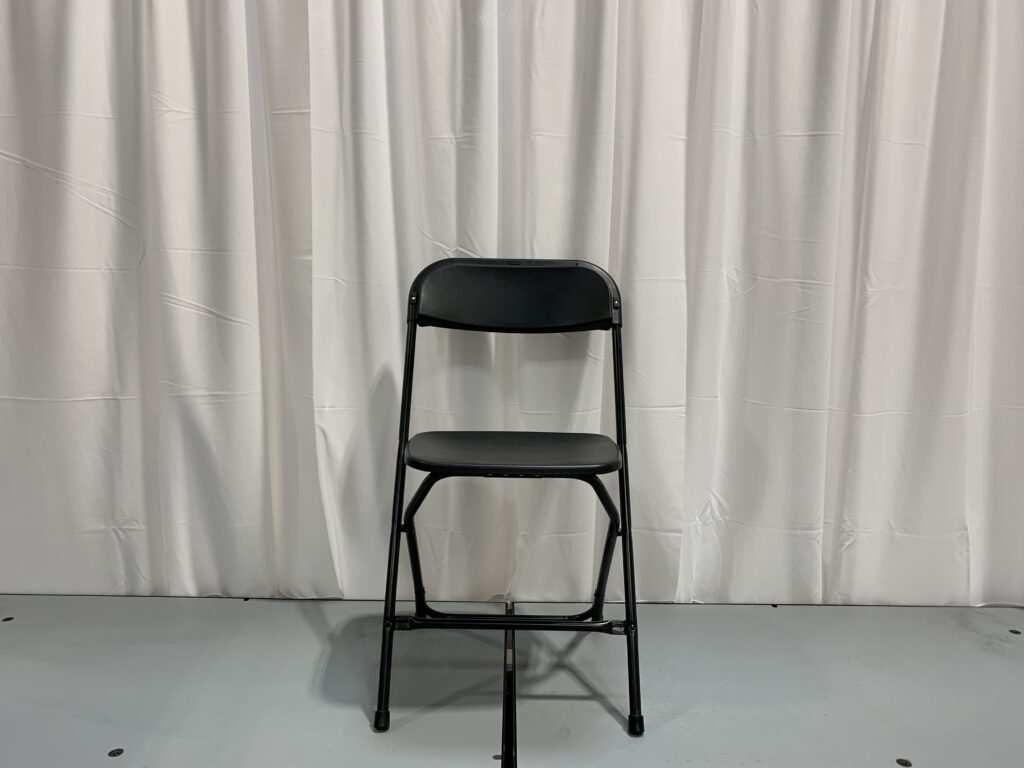 Black folding chair displayed.