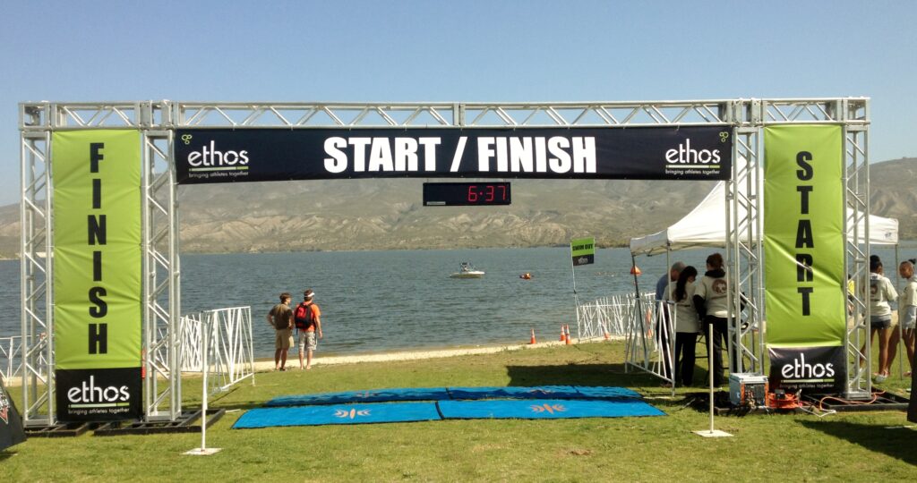 Start / Finish line set up outside with lake in the background.