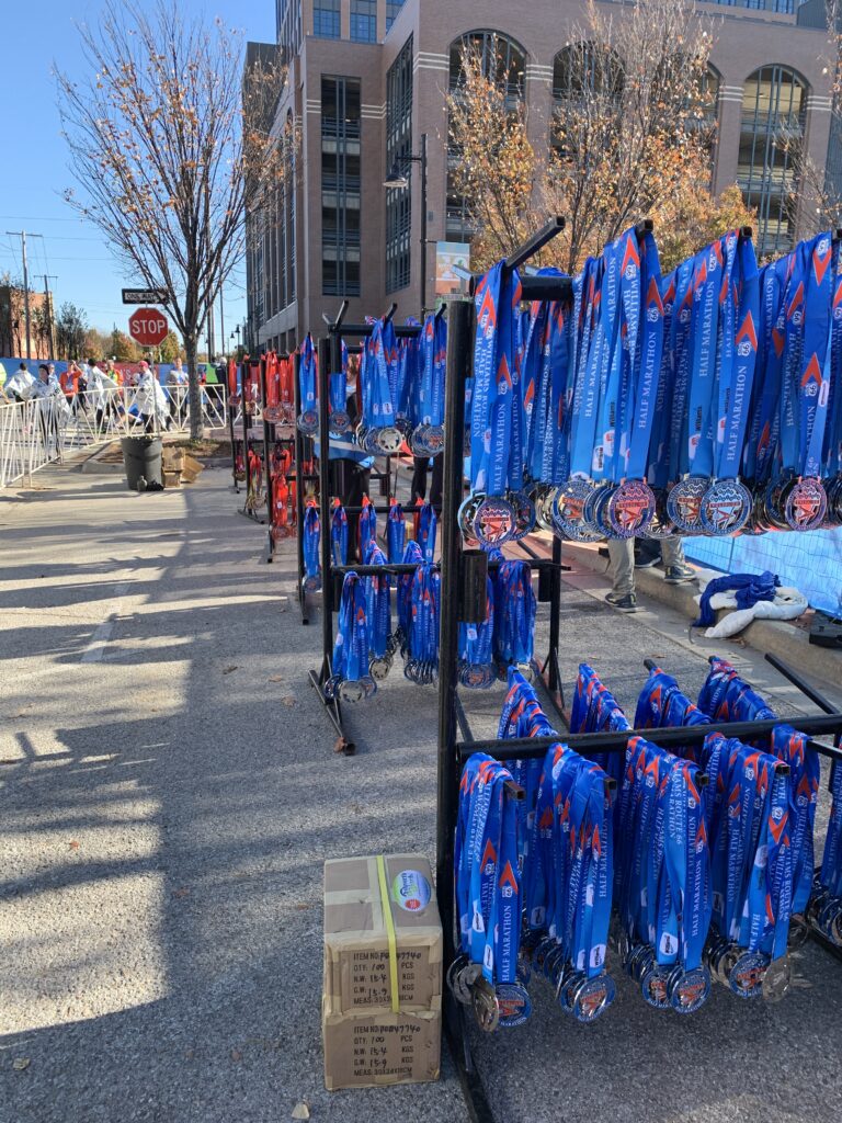 Medal stands set up outside displaying hundreds of blue medals.