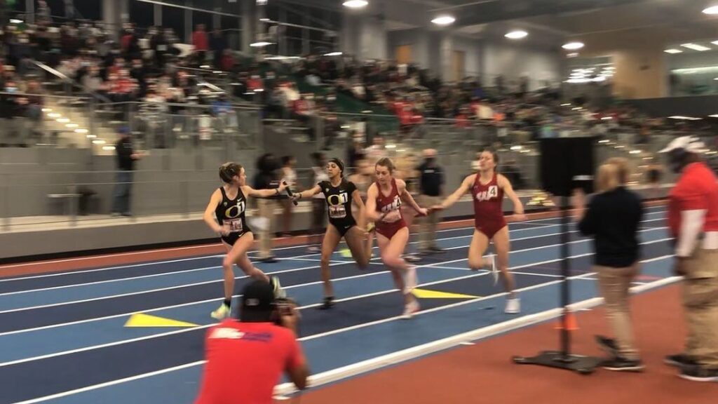 Young woman racing on an indoor track.