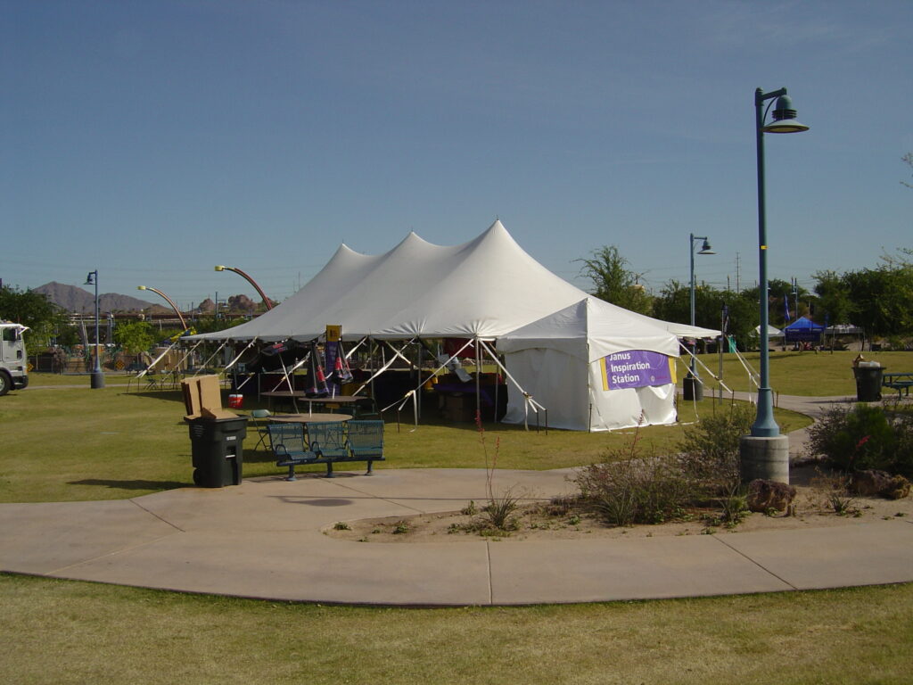 Large white pole tent set up outside.