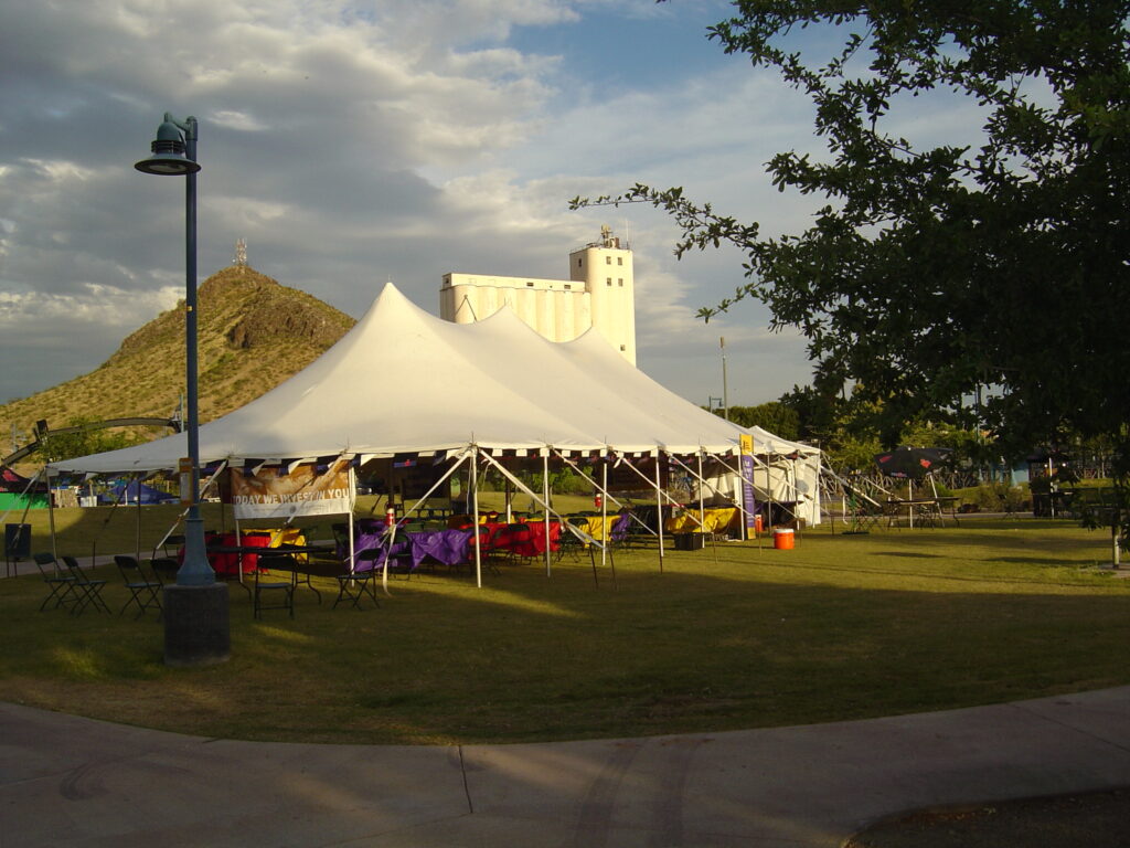 Large white pole tent set up outside.