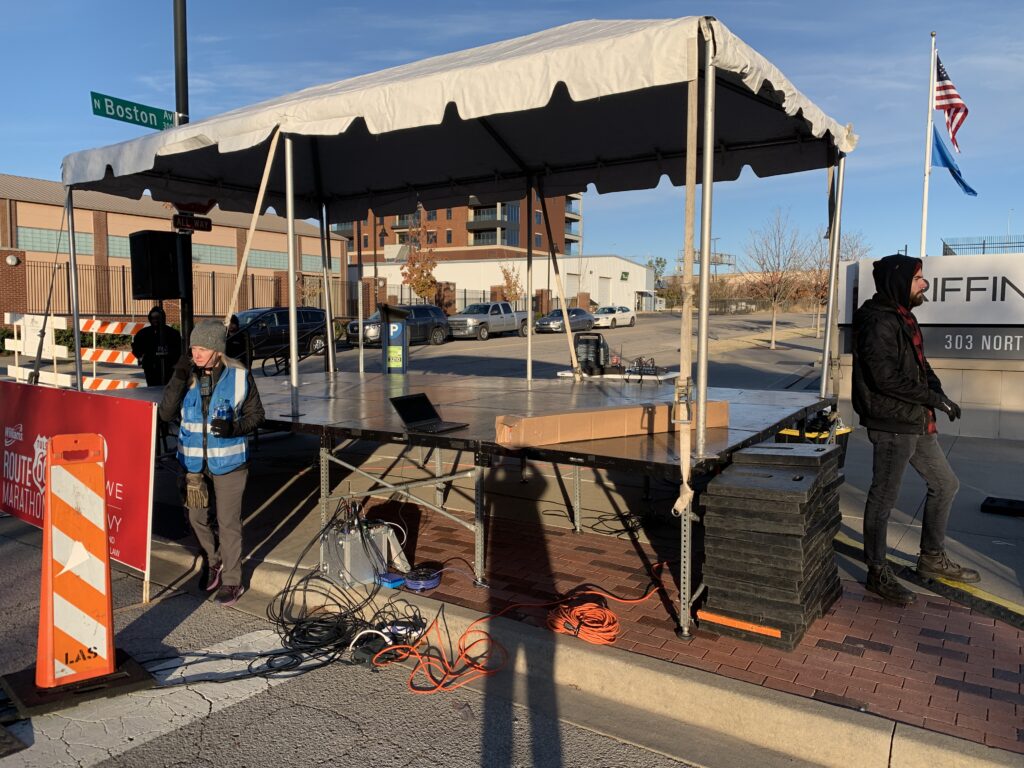 Stage with tent set up outside.